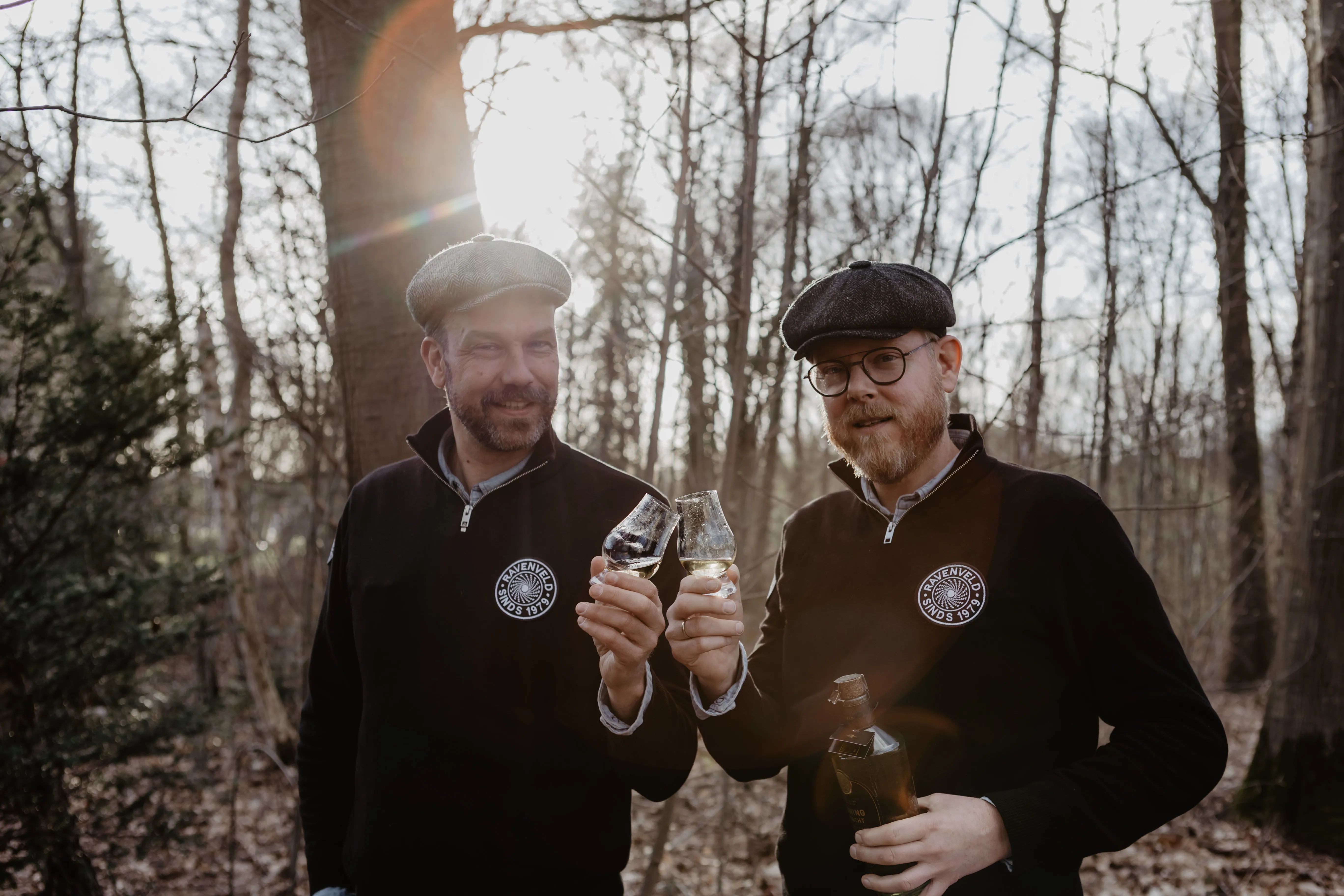 Dirk-jan en Michiel met klinkende glazen in het bos